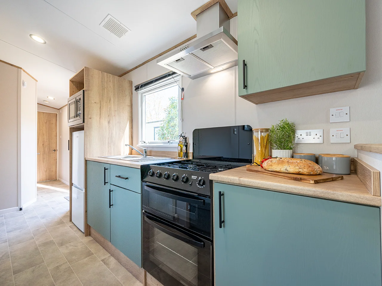 ABI Coworth Kitchen - Grey / blue cabinets and black cooker with hood