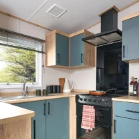 ABI_2024_kitchen - wooden topped, blue fronted units with black cooker